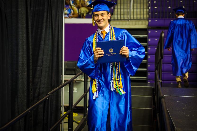 A group of graduates wearing blue robes